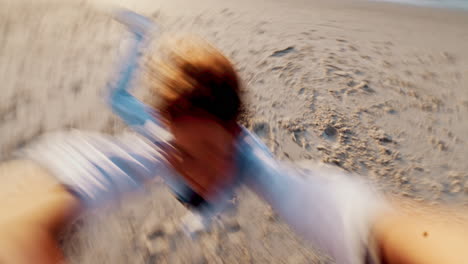 child, pov and spinning on beach happy for summer