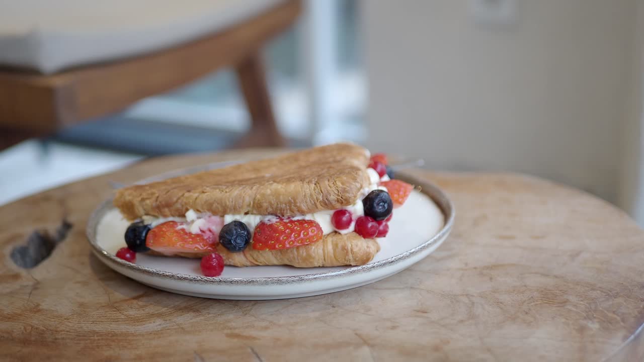 Delicious Croissant Sandwich with Fresh Berries and Cream