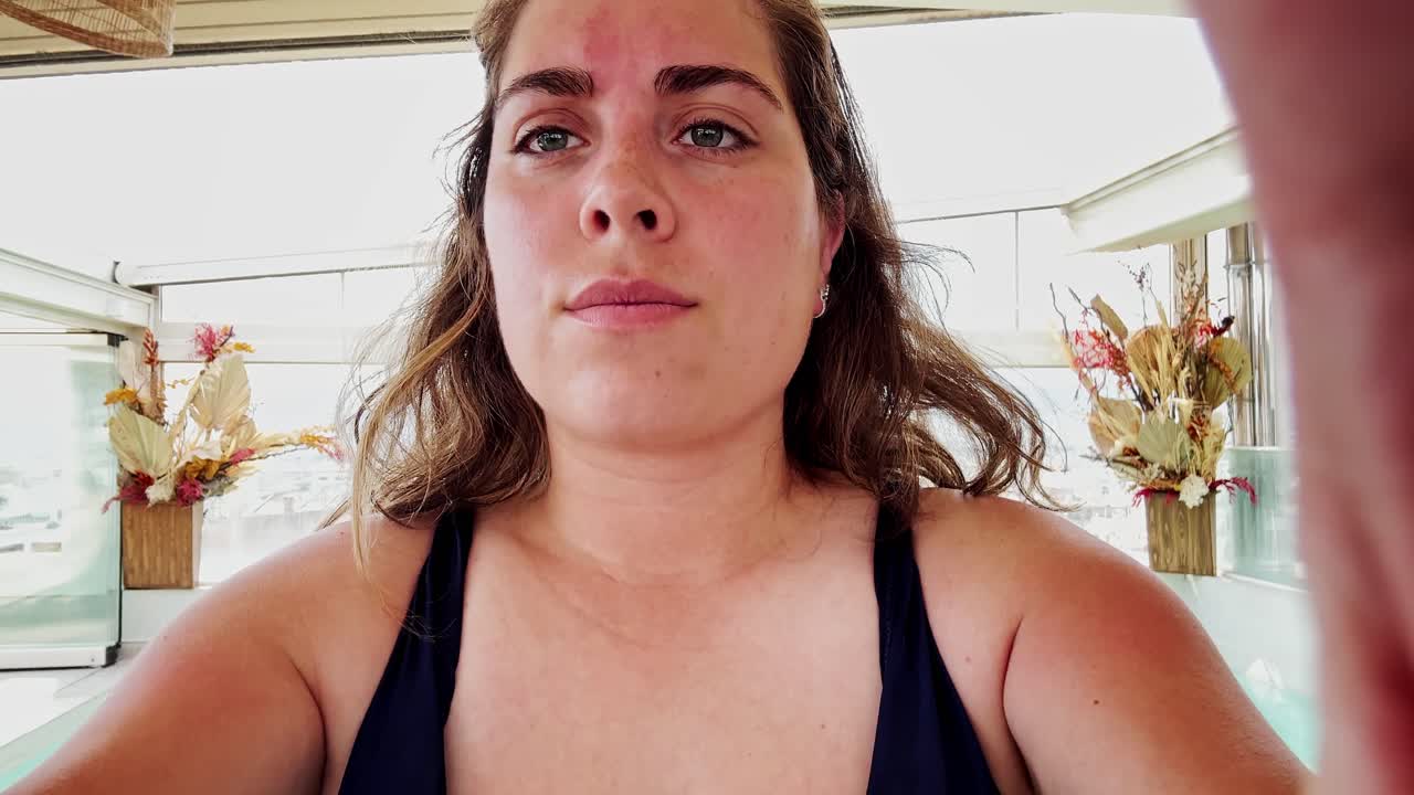 Woman enjoying a sunny day at a rooftop cafe