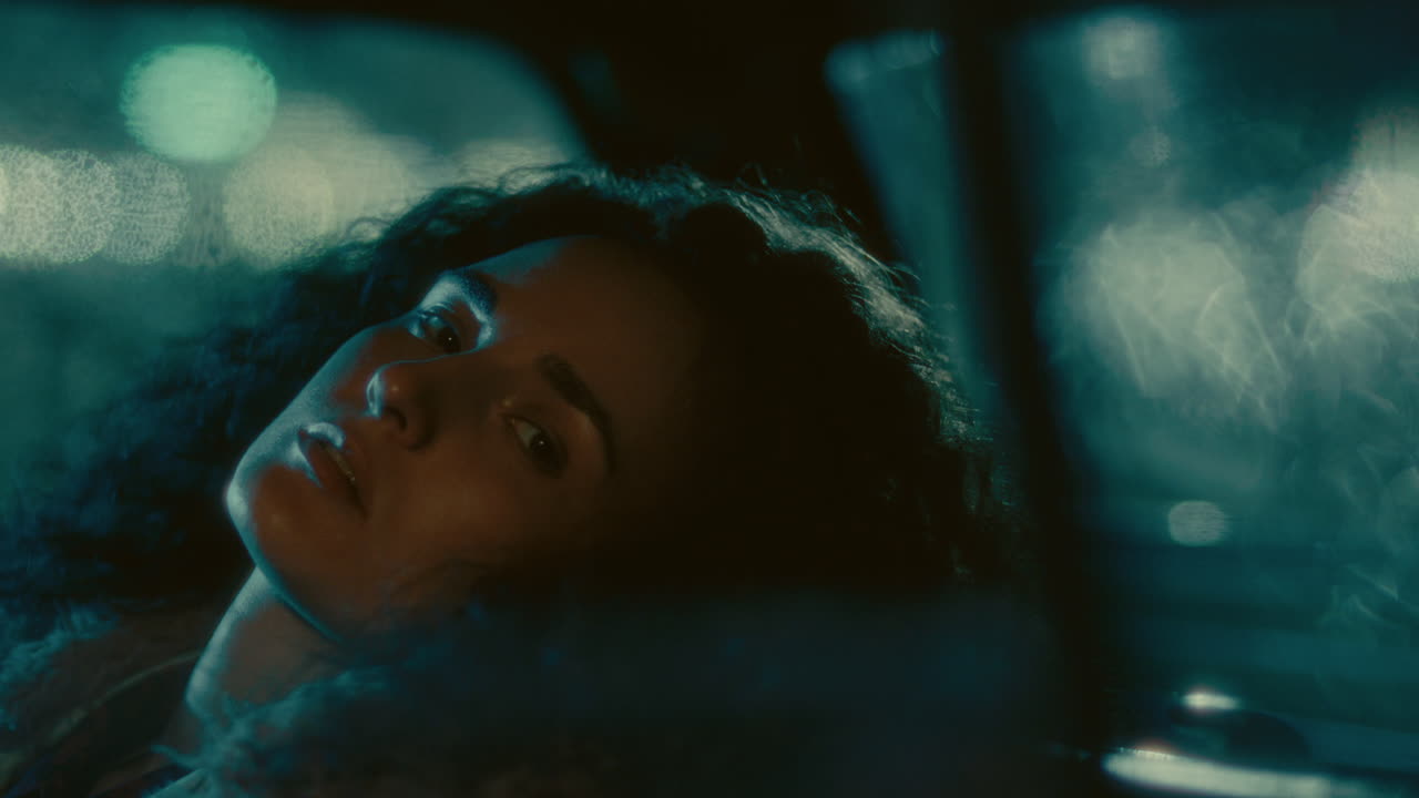 Portrait of Thoughtful Girl Leaning Back in Car Seat at Night