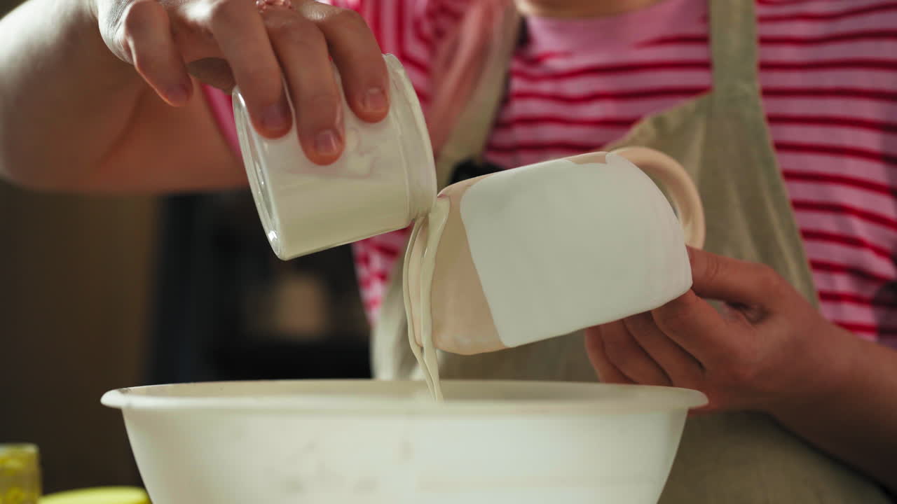 Glazing Ceramic - Person Pouring And Applying The Glaze To Bisque-ware Cup.