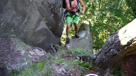 man climbing topless on the rock