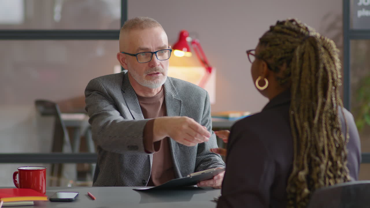 Senior Recruiter Shaking Hands with Female Candidate on Job Interview