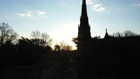 a low angle shot of a cathedral with a tall steeple at sunrise