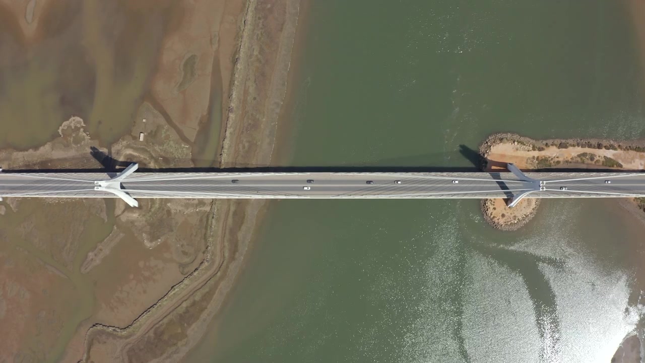 Vista superior de vehículos cruzando el Nuevo Puente de Portimão sobre el río Arade en el Algarve, Portugal. Toma aérea cenital