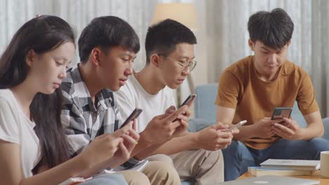 group of young adults using smartphones