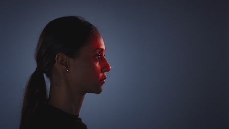 Facial-Recognition-Technology-Concept-As-Woman-Has-Red-Grid-Projected-Onto-Face-In-Studio