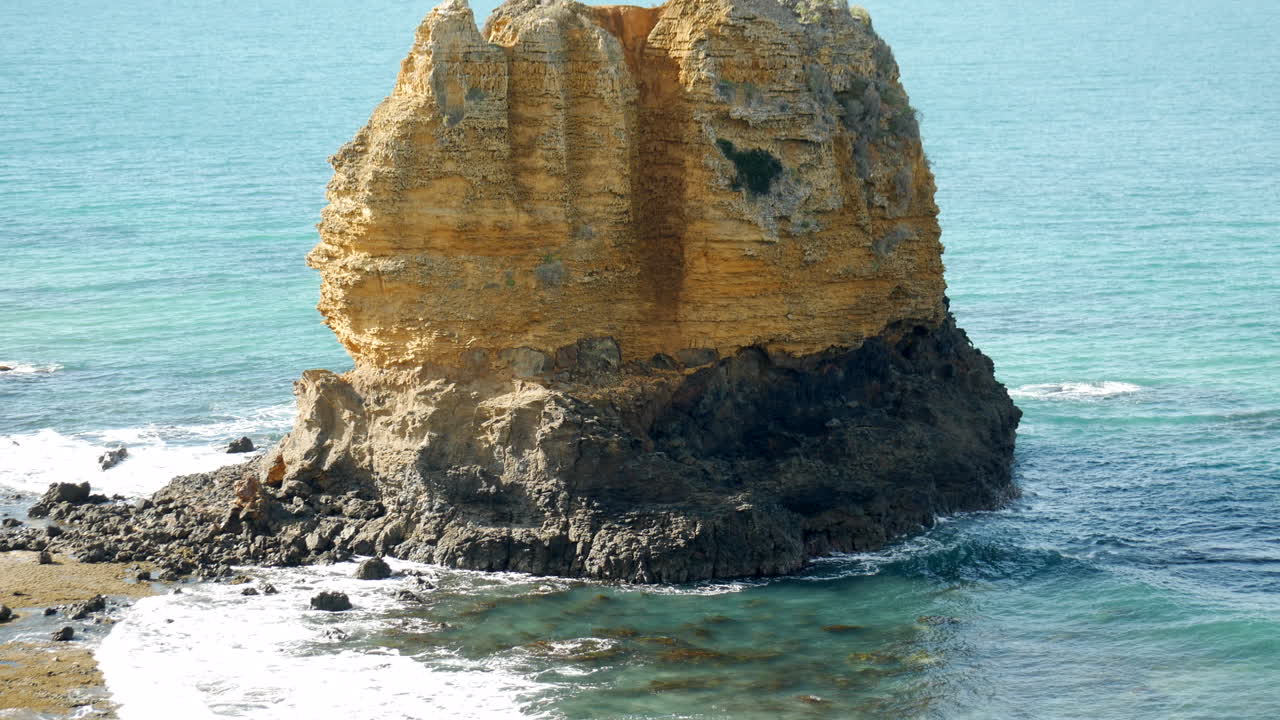 Large rock formation located along an Australian coastal town shot from high