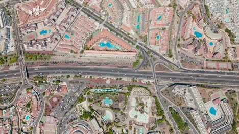 aerial shot over tourist area with resorts and hotels with swimming pools