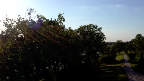 Aerial-shot-ascending-over-some-trees-to-reveal-a-wide-calm-river