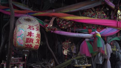 Close-up-of-a-sacred-fig-tree-with-colored-ribbons-and-lampion-in-Bangkok,-Thailand