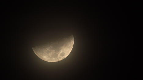 half moon moving in dark sky