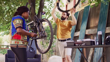 multiracial couple fixes broken bicycle