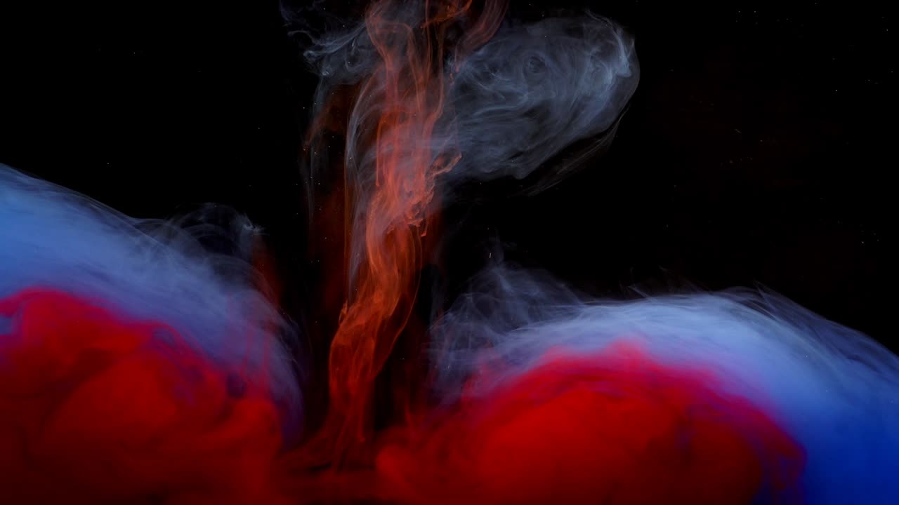 Abstract forms. Shooting on a black background. Mixing of paints
