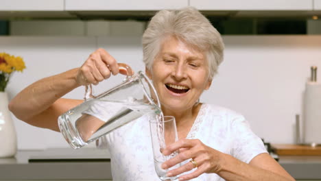 happy woman pouring glass of water