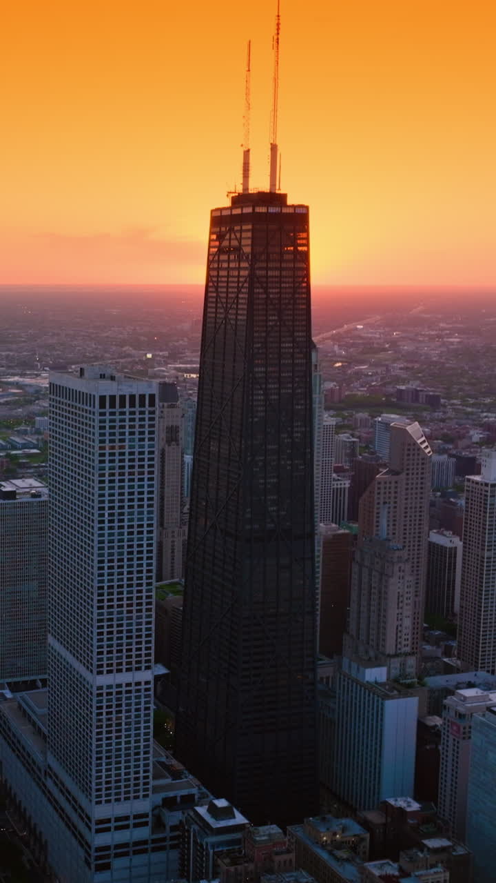 Splendid scenery of vast Chicago at setting sun. Metropolis skyline against orange skies backdrop. Vertical video