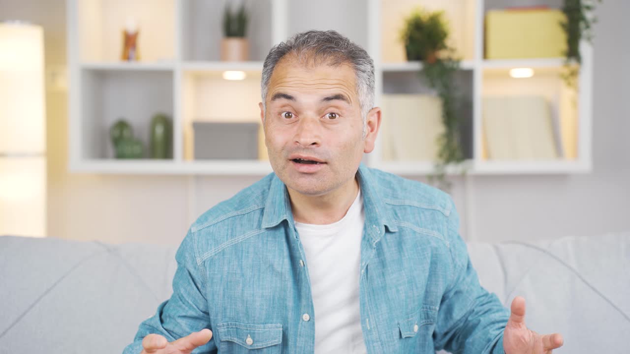 The man says wow to the camera.