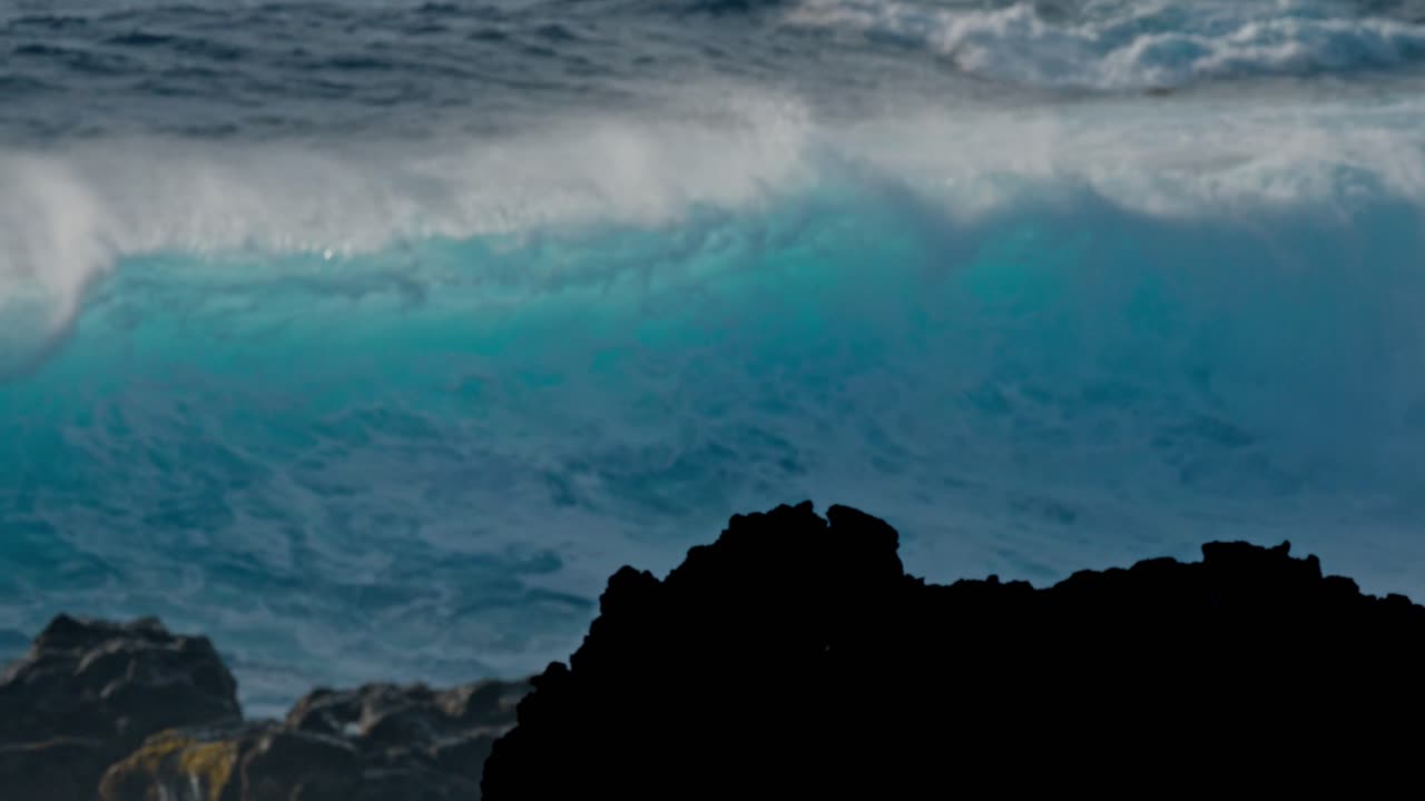 Dramatic ocean waves collide with the volcanic coastline near Timanfaya National Park, located on the island of Lanzarote in the Canary Islands, Spain.
