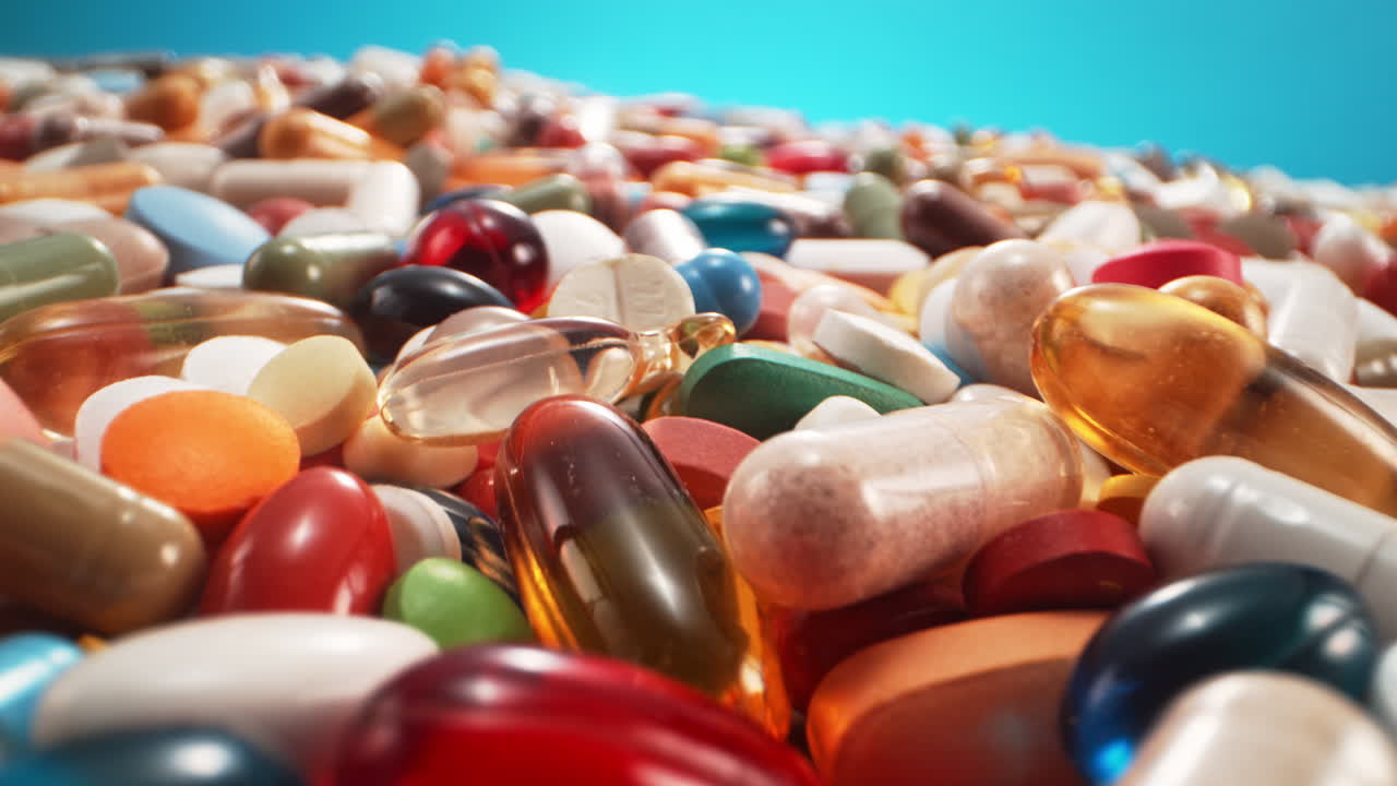 Pile Of Colorful Drugs Up To The Horizon in Macro, Blue Background, Camera Tilts in Slow Motion