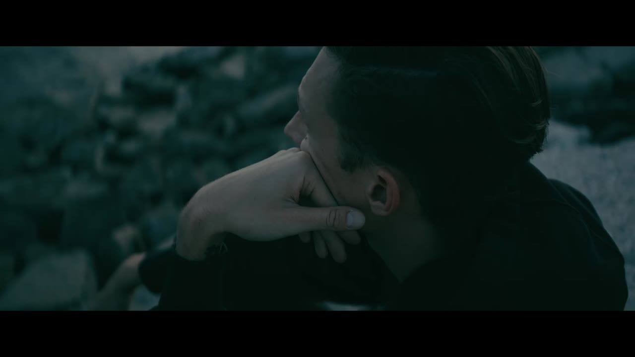Man in contemplation by the water