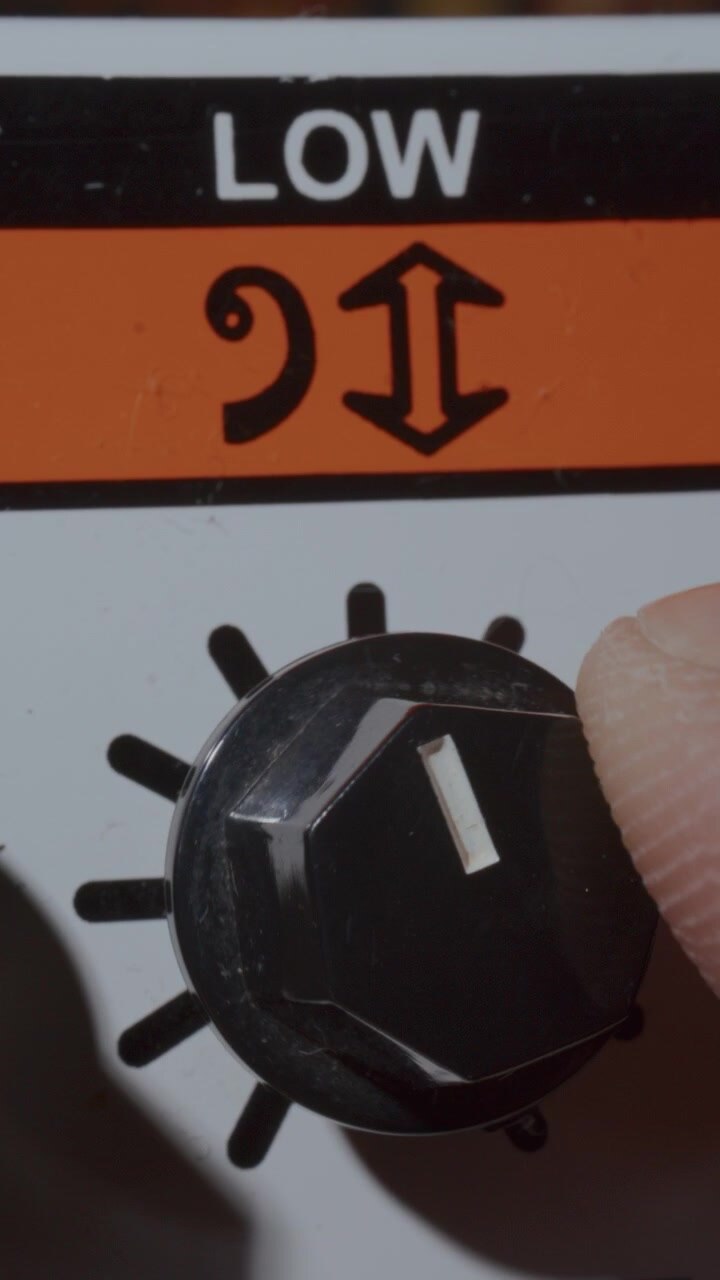 Extreme Close Up of Adjusting Low Frequency Knob on Retro Amplifier