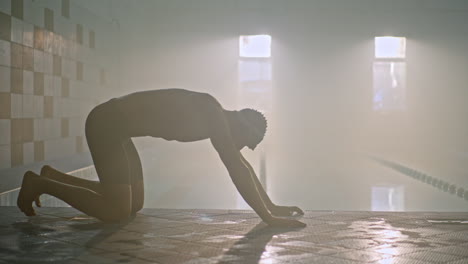 swimmer stretching by the pool
