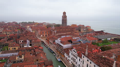 venetian tower under construction work while seagulls fly. aerial