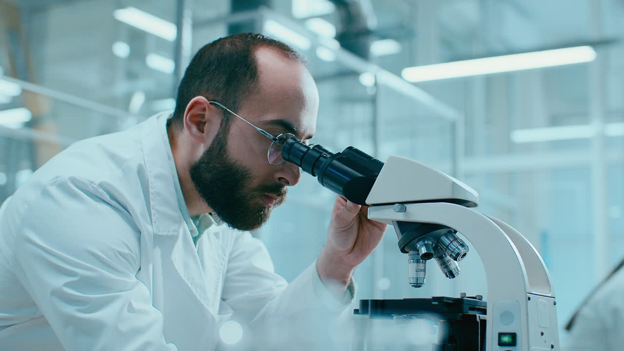 Scientist Conducting Microscopic Research in Advanced Laboratory