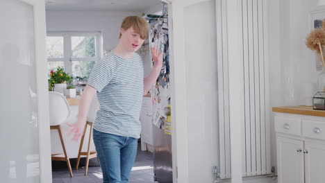 Young-Downs-Syndrome-Man-Having-Fun-Dancing-At-Home