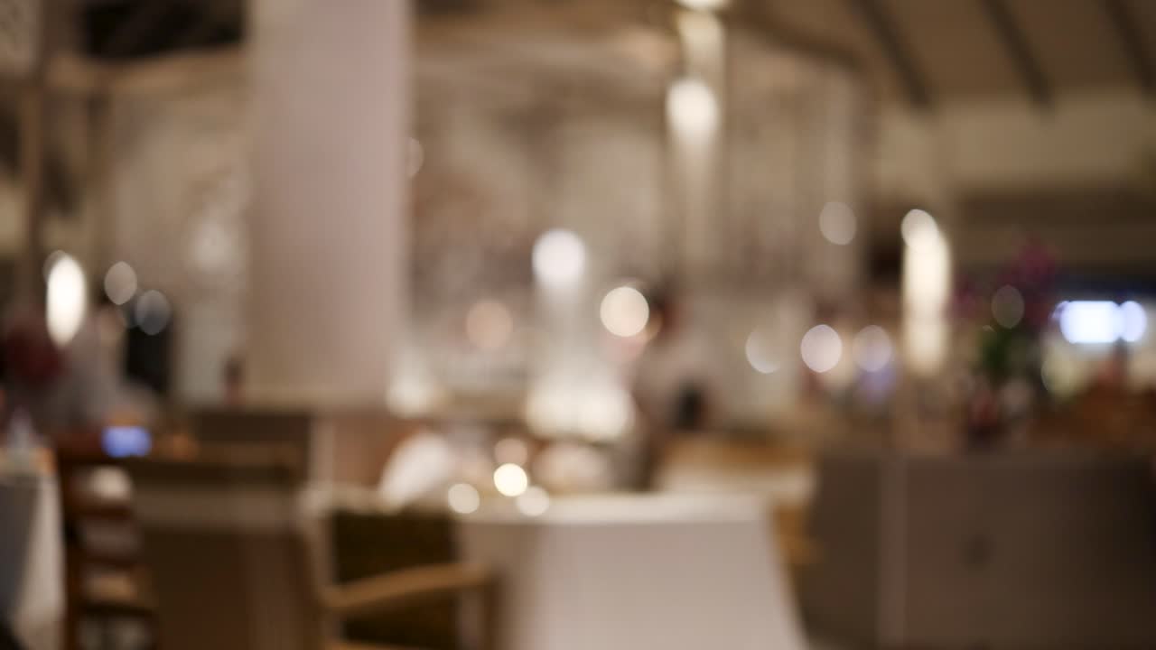 밤에는 비는 태국 레스토랑의 흐릿한 시야, 주변 조명과 활기찬 분위기를 포착합니다.