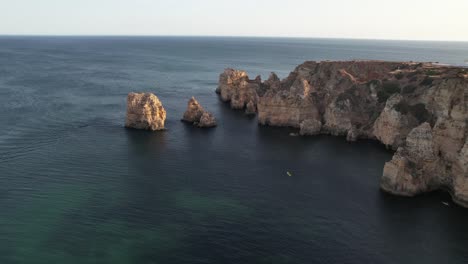 Aerial-Footage-From-Flying-Drone-Of-Tourist-Yachts-On-Clear-Blue-Water-In-Lagos,-Portugal