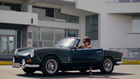 couple at airport with vintage convertible