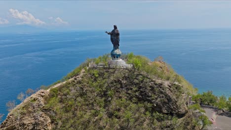 cape fatucama, dili, east timor - cristo rei of dili statue - aerial pullback shot