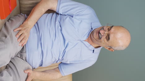 Vertical-video-of-Old-man-waiting-for-someone-at-home.