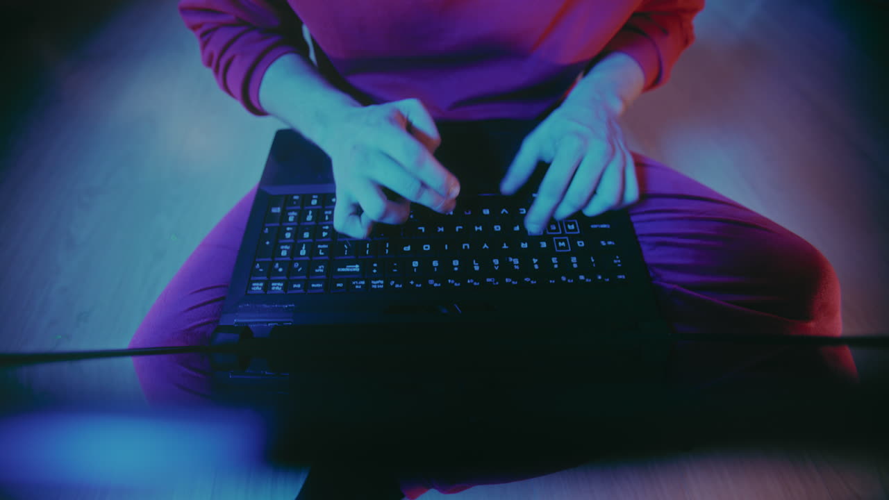 Man working speedily on laptop at illuminated home during Christmas