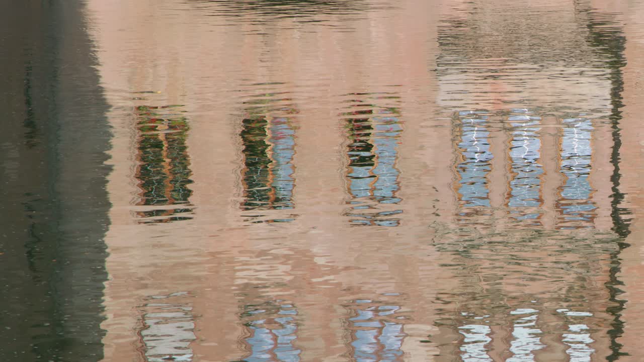 Rippling water reflects historic architecture, soft daylight, and subtle camera movement in Nuremberg canal