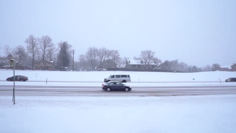 slow motion footage of cars driving on snow covered road