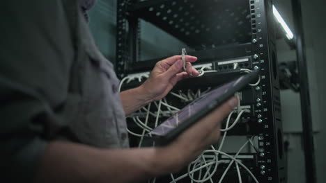 technician working on server rack in data center