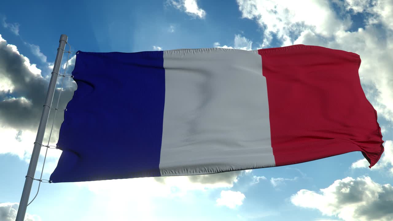 The national flag of France is flying in the wind against a blue sky