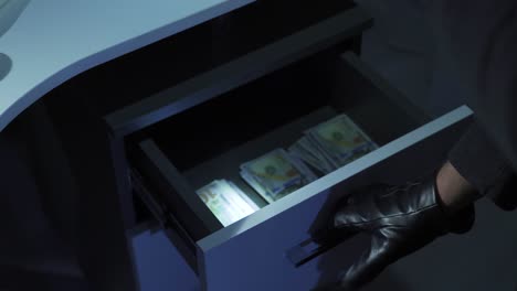 the thief steals money from the safe.