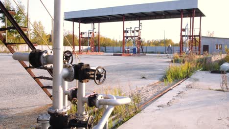 abandoned gas station with pipes and valves