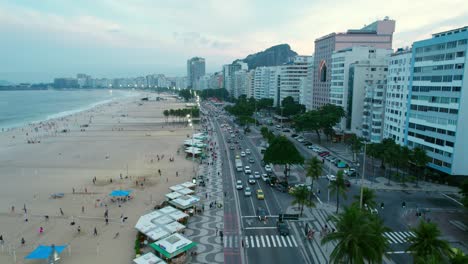 Aerial-orbit-establishing-of-Copacabana-waterfront-with-cars-passing-by-in-Rio-de-Janeiro-Brazil,-Guanabara-bay