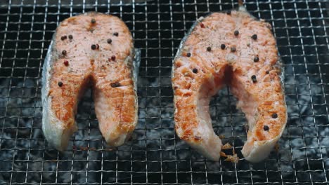 grilled salmon steaks on bbq grill. close up grilling salmon fillet on charcoal