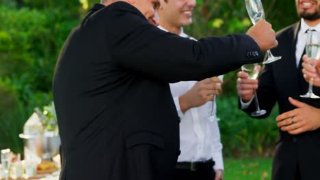 father of the bride toasting champagne with groom and guest 4k 4k