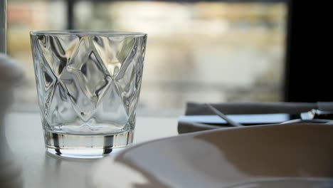 restaurant interior with water glass and view