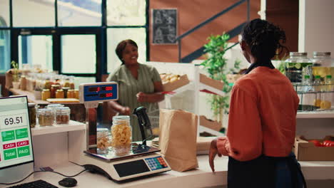 local merchant placing groceries on scale at cash register