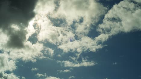 4k timelapse of a sunny blue sky, with clouds passing by in front of the sun