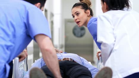 rear view of doctors running to the operating room