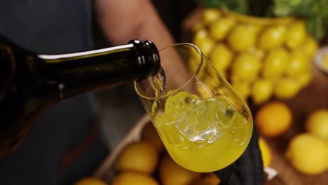 pouring a refreshing yellow cocktail