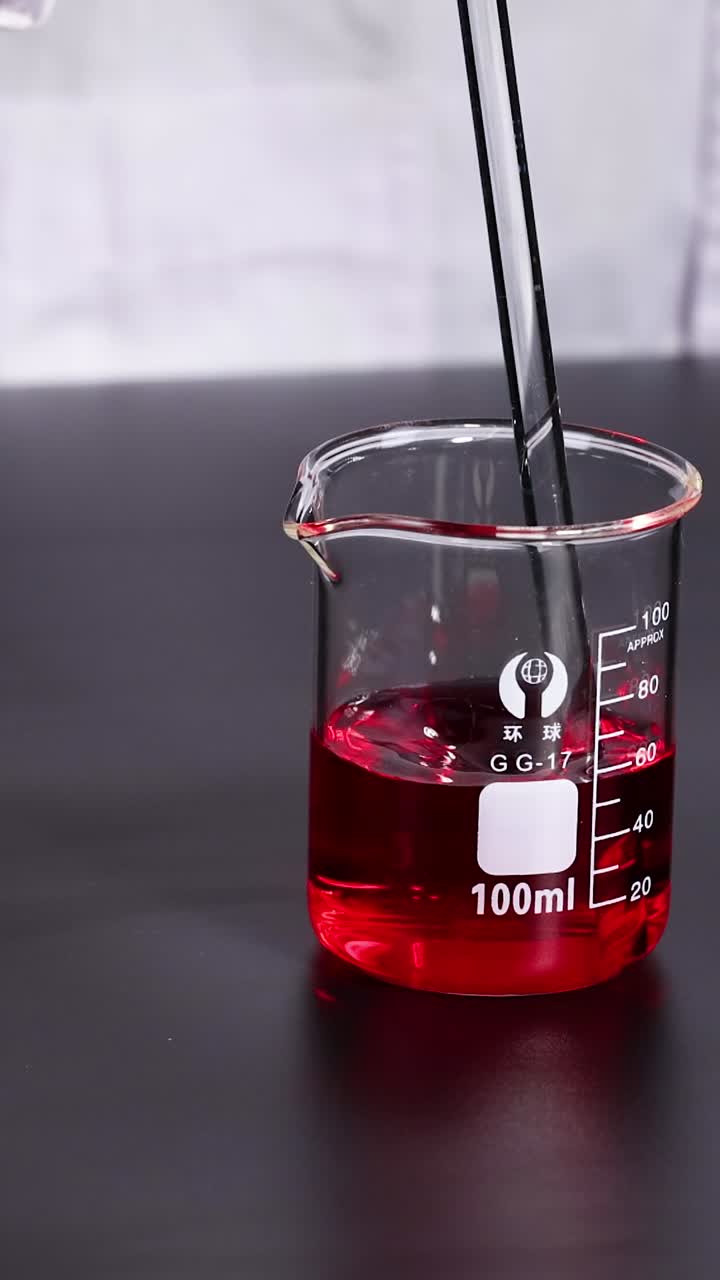 Experiment with red liquid in a beaker